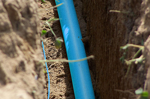 Blue piping in the ground