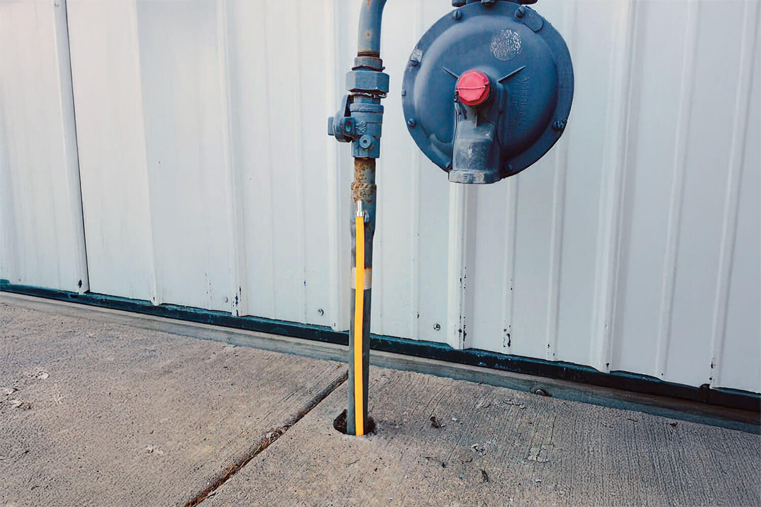 Yellow SnakeSkin Access Point installed on side of pipe