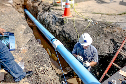 Group of workers working on a water pipe