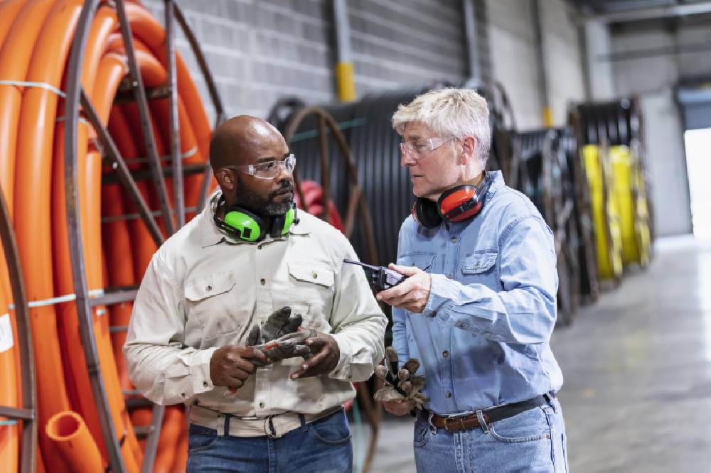 Two men walking in a warehouse