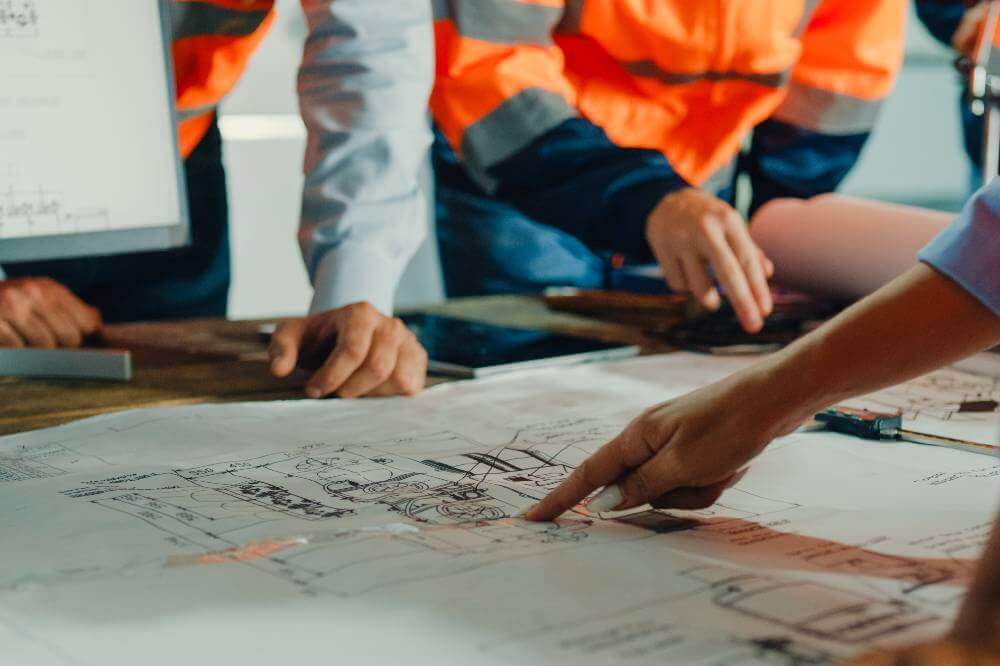 Group of people reviewing plans on a paper